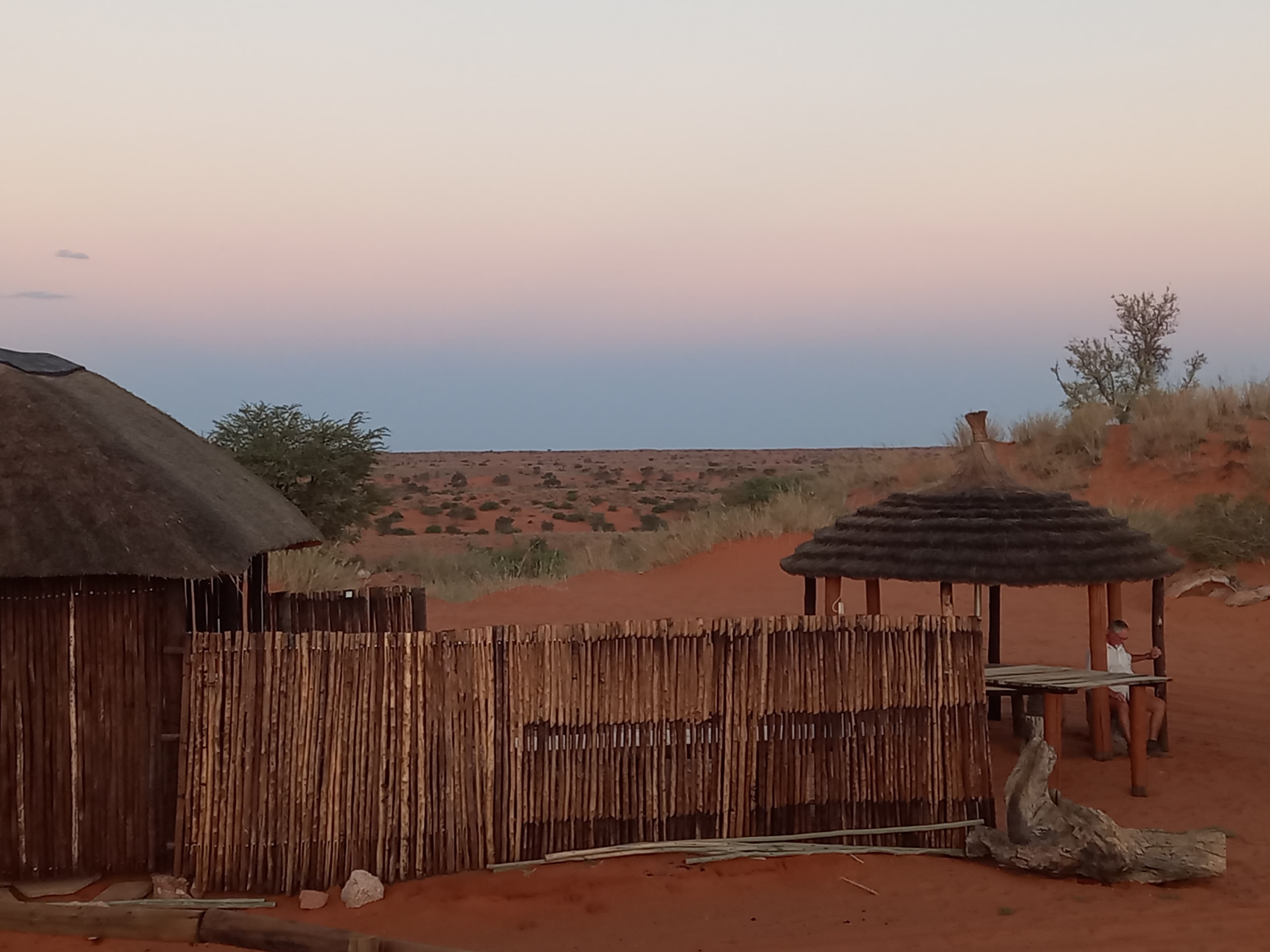 Stone building with green lawn at Red Dune Camp